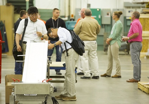 Two professional with backpacks demo conveyor belt