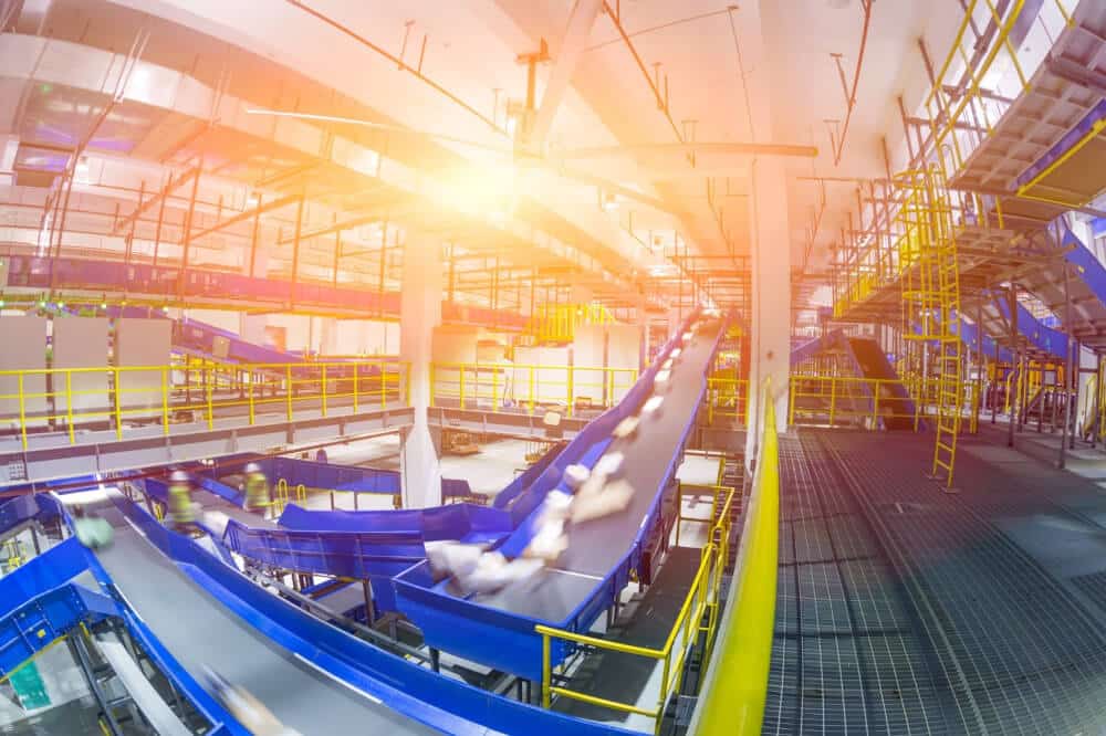 Interior of an automated warehouse with belted conveyors operating efficiently.